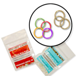 Orthodontic elastics and accessories displayed in organized storage containers with magnified view.