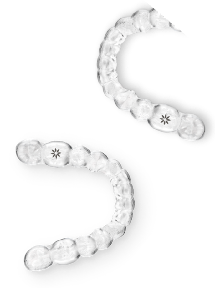 Clear orthodontic aligners arranged in curved rows demonstrating progressive teeth straightening treatment stages.